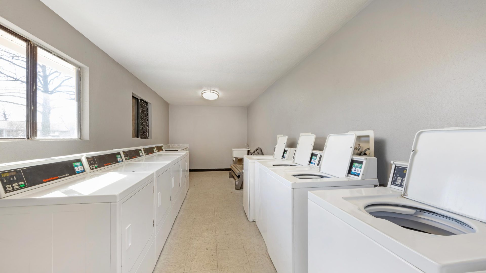 a laundry room with washers and dryers at The  Darby