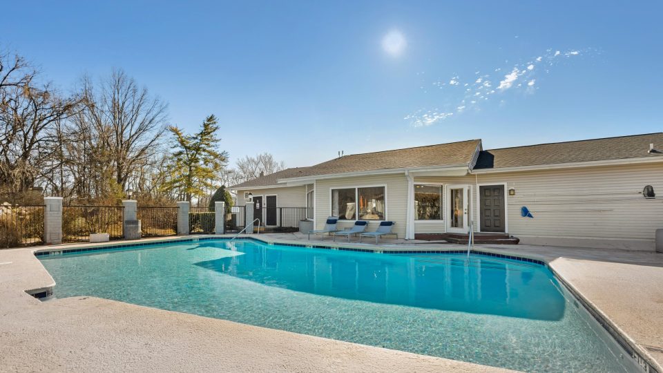 a large pool in front of a house at The Darby