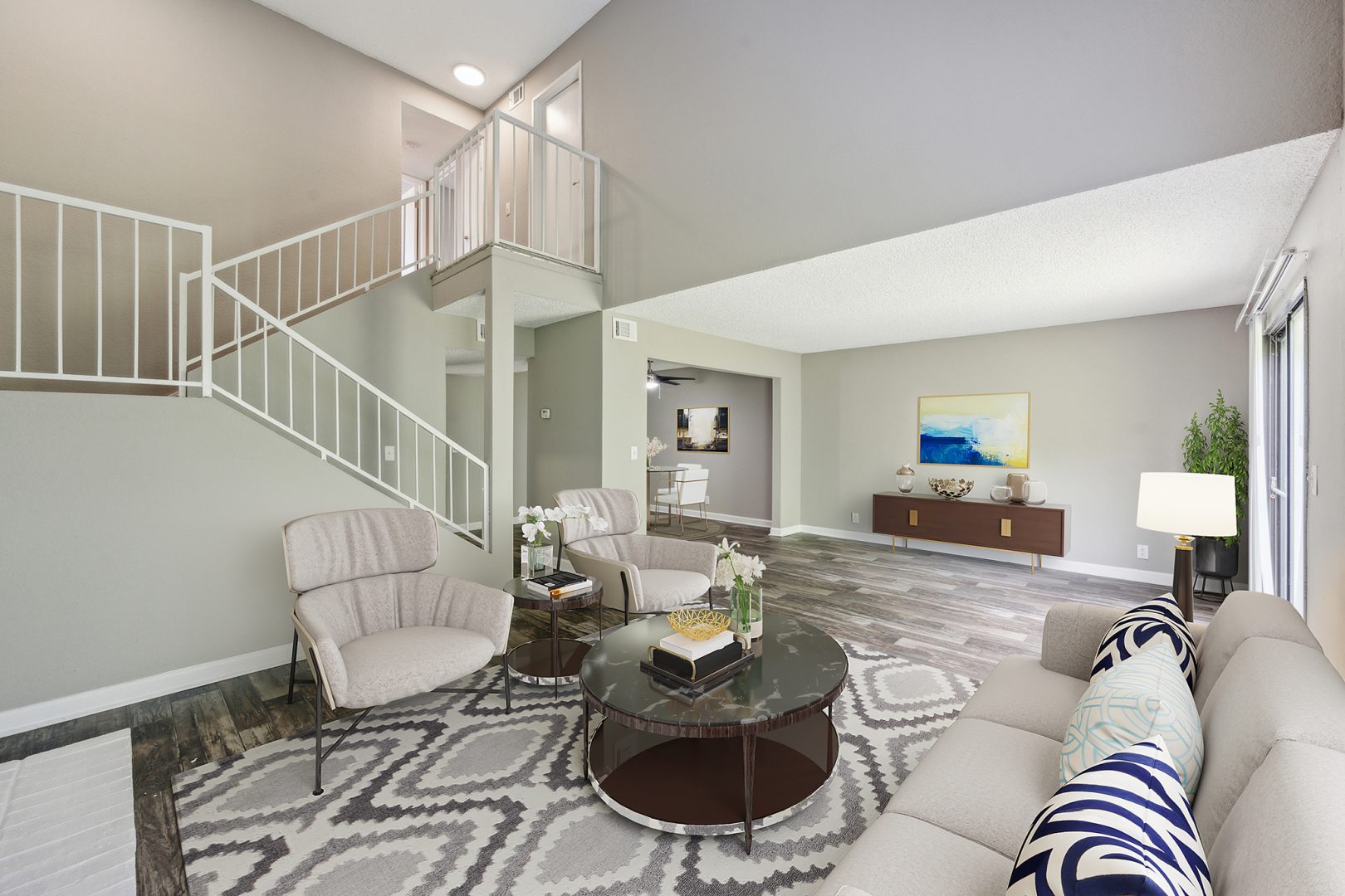 a living room with a staircase and a couch at The  Darby