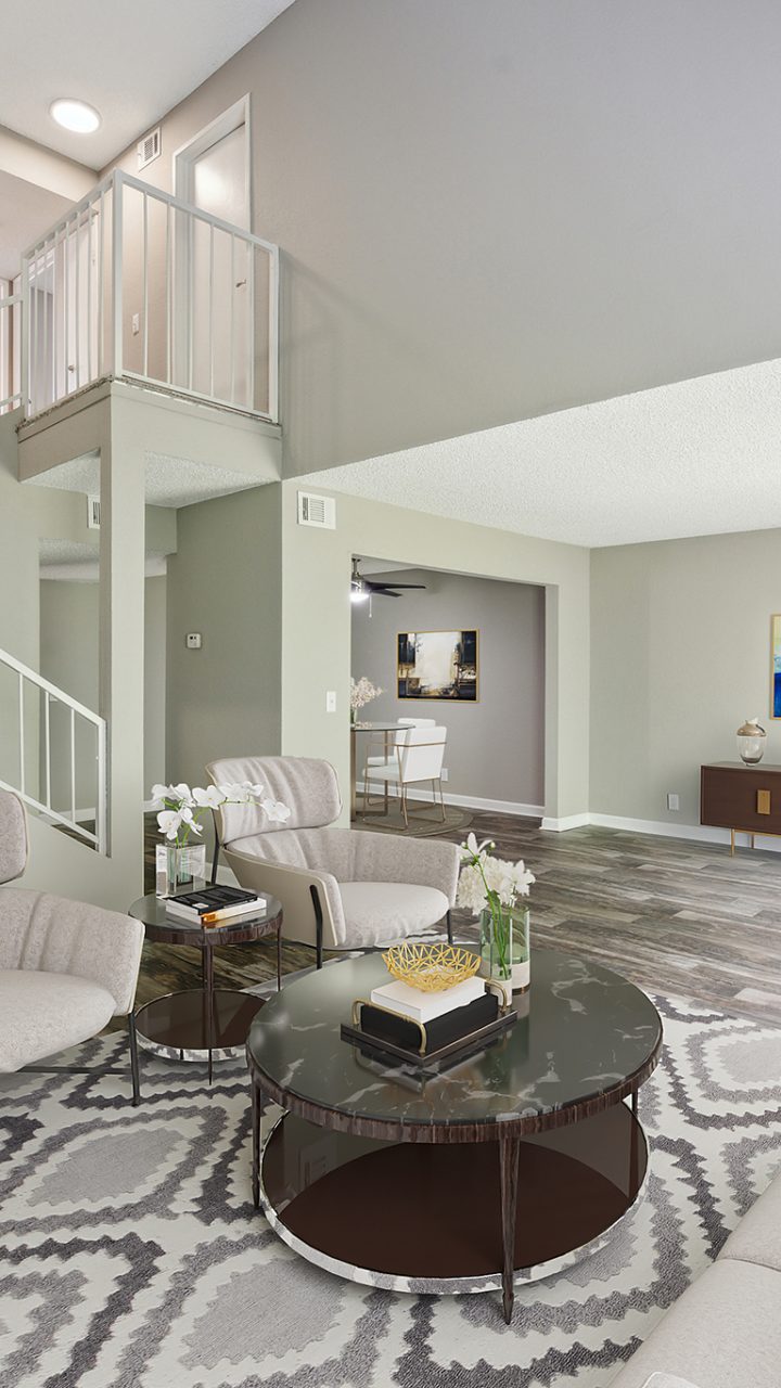 a living room with a staircase and a couch at The  Darby
