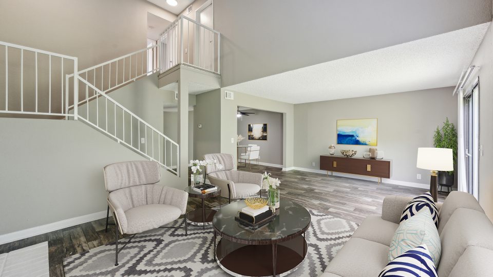 a living room with a staircase and a couch at The Darby