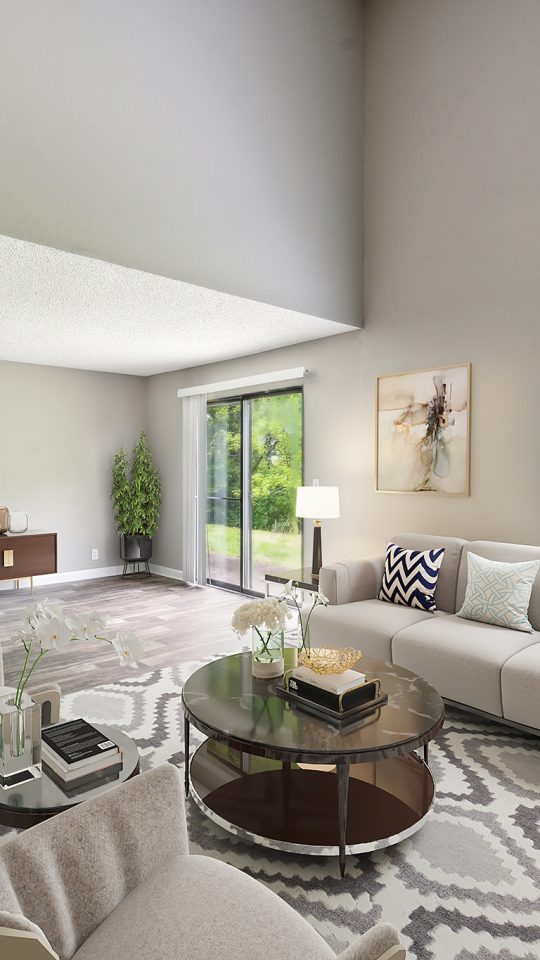 a living room with a large window and a couch at The  Darby
